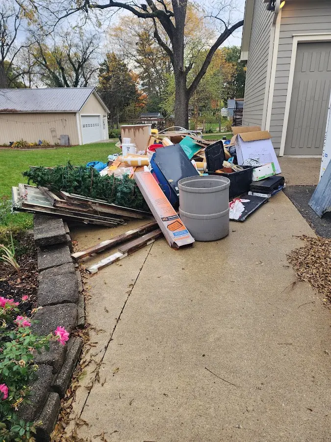 Dumpster being loaded with debris for Commercial Dumpster Rental in Fruit Cove